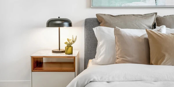 Bedroom detail shot featuring bed and bedside table at The Manett