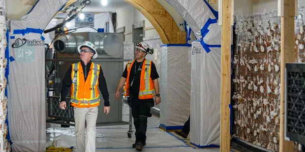 Two Inflector employees walking on a job site