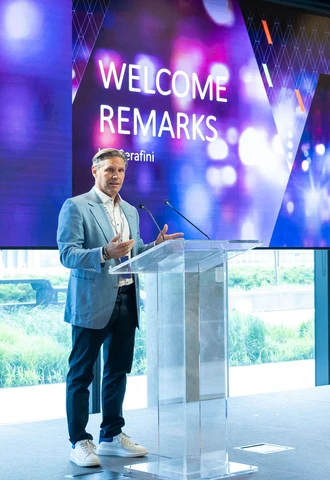 Lou speaking at a podium