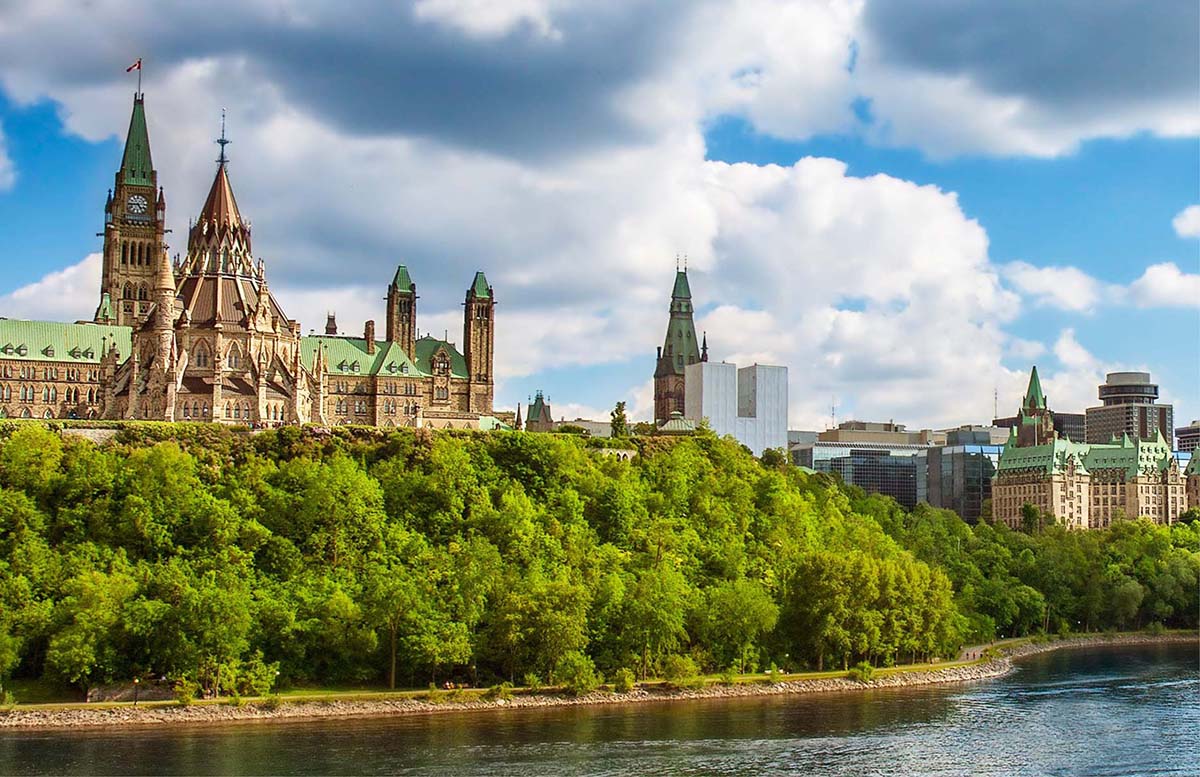 parliament buildings in ottawa from river
